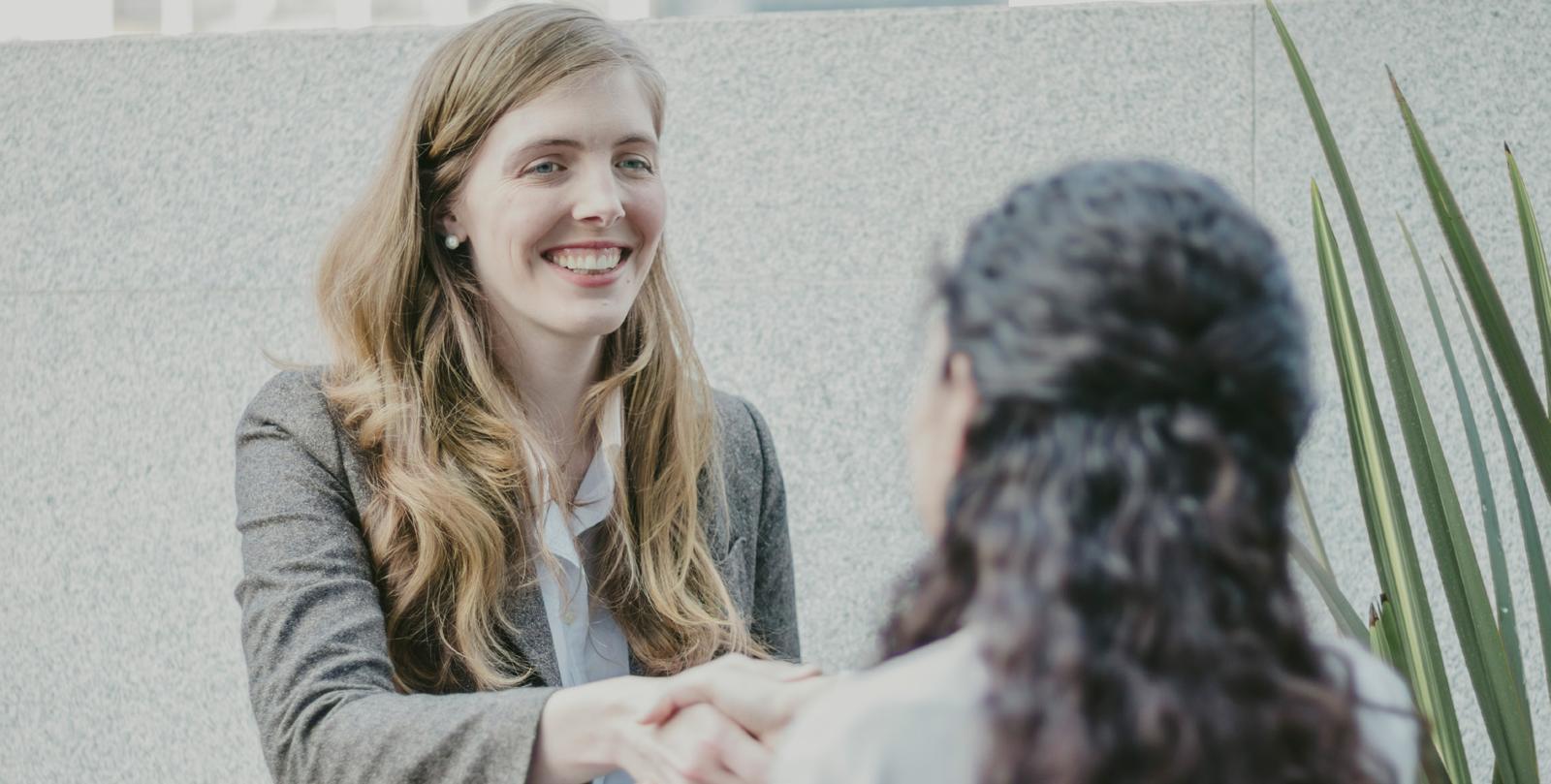 Two business professionals shaking hands after a meeting